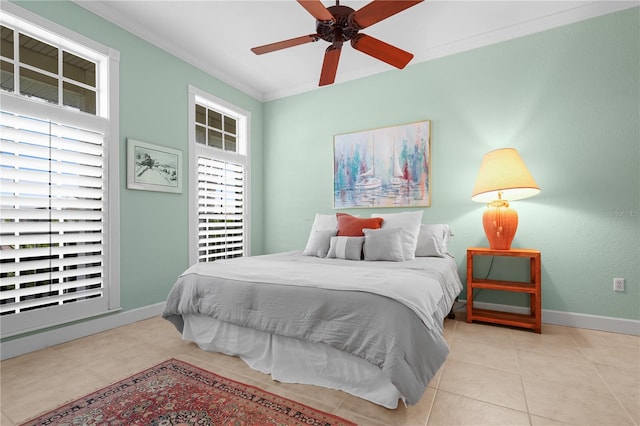 bedroom with ceiling fan, ornamental molding, and light tile patterned floors