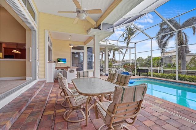 view of patio featuring glass enclosure and ceiling fan