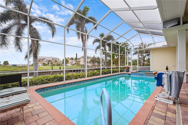 view of pool featuring an in ground hot tub, a lanai, and a patio area