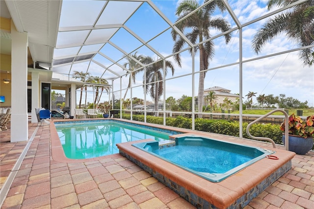 view of swimming pool featuring an in ground hot tub, glass enclosure, and a patio