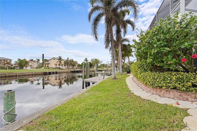 dock area with a water view and a lawn