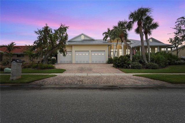 view of front of house featuring a lawn and a garage