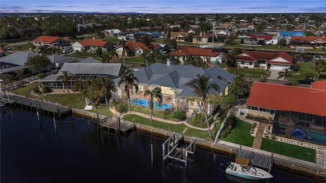 drone / aerial view featuring a residential view and a water view