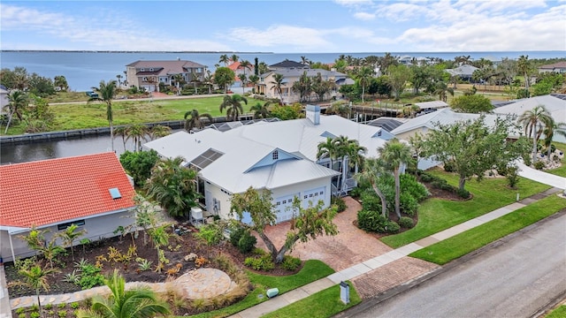 drone / aerial view with a water view and a residential view