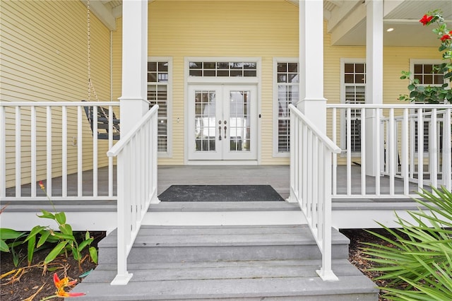 property entrance featuring french doors and a porch