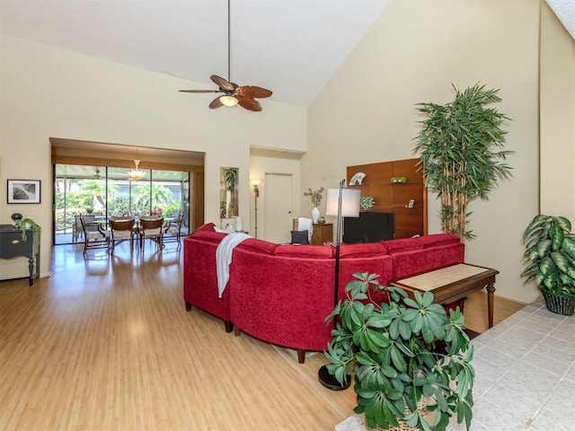 living room with high vaulted ceiling, hardwood / wood-style floors, and ceiling fan