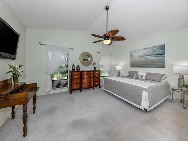 bedroom with lofted ceiling, ceiling fan, and carpet floors