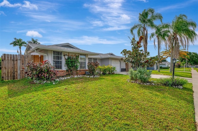 view of front of house with a front yard and a garage