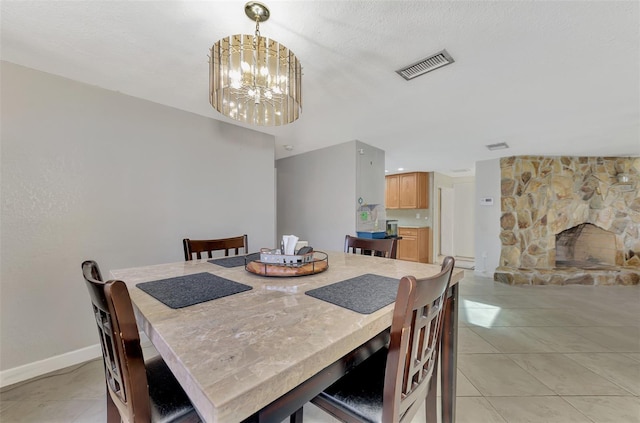 tiled dining space with an inviting chandelier