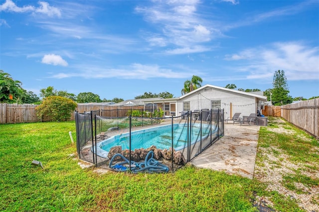 view of pool with a patio and a yard