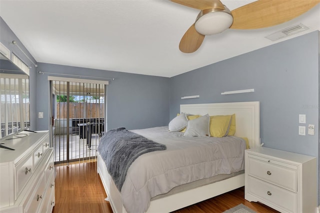 bedroom featuring ceiling fan, dark wood-type flooring, and access to exterior