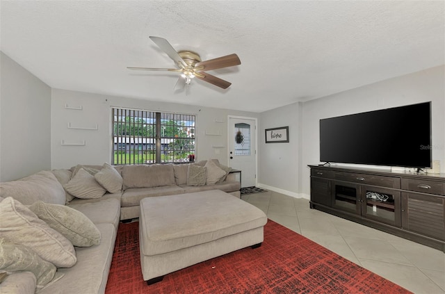 tiled living room with ceiling fan and a textured ceiling