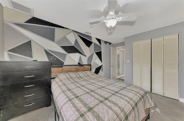 bedroom featuring ceiling fan, light tile patterned flooring, and a closet