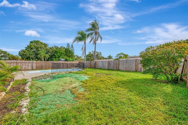 view of yard with a fenced in pool and a patio