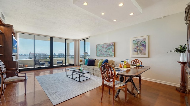 dining room featuring a textured ceiling, dark hardwood / wood-style floors, and expansive windows