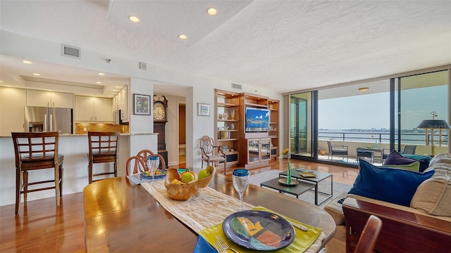 living room featuring expansive windows and a textured ceiling