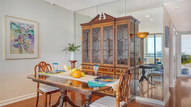1255 N Gulfstream Ave Unit 1003, Sarasota, FL 34236 - dining area featuring baseboards, wood finished floors, and recessed lighting