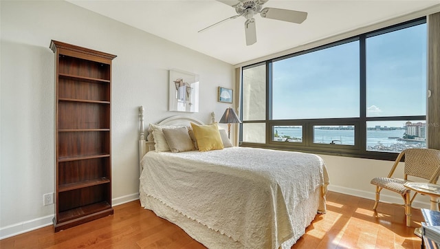 bedroom with ceiling fan and hardwood / wood-style floors