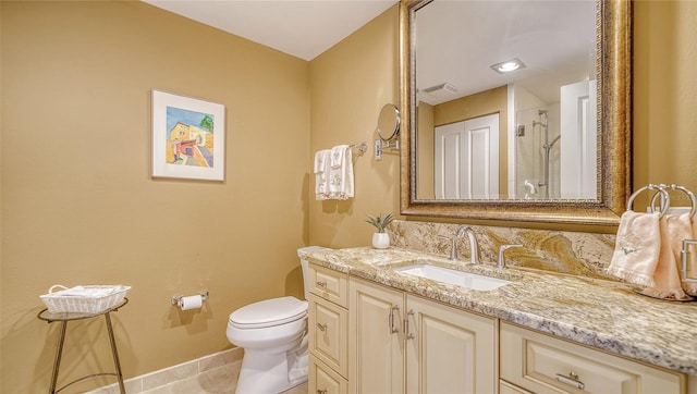 bathroom featuring vanity, a shower, toilet, and tile patterned floors