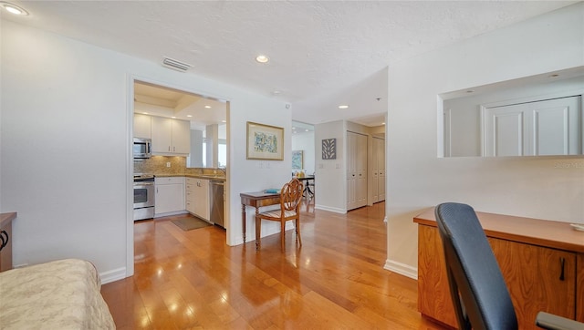 1255 N Gulfstream Ave Unit 1003, Sarasota, FL 34236 - office area with light wood-type flooring, baseboards, recessed lighting, and a textured ceiling