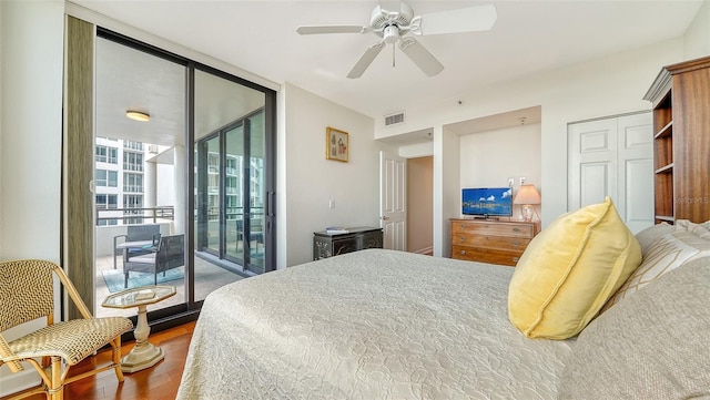 bedroom featuring access to outside, hardwood / wood-style floors, and ceiling fan