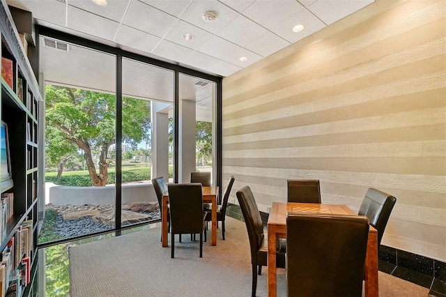 dining area with carpet floors and a wealth of natural light