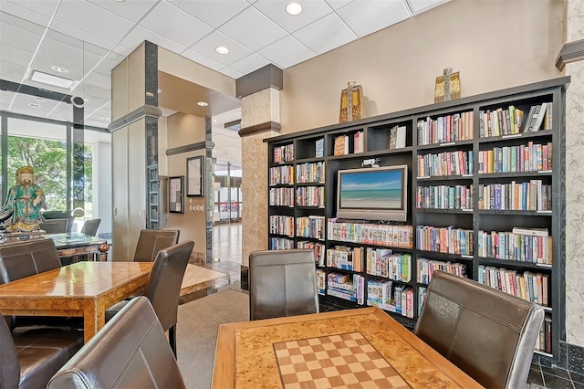 interior space with a paneled ceiling