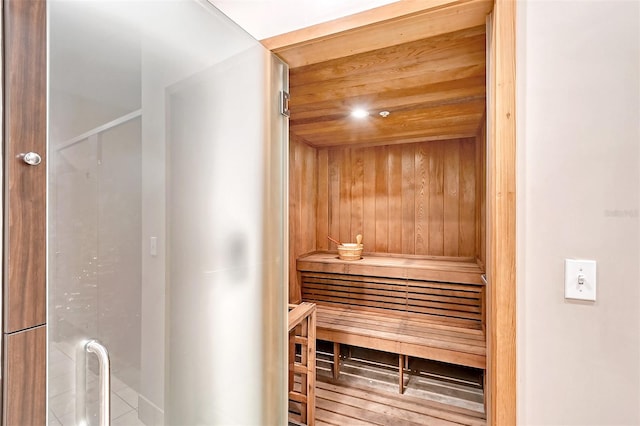 view of sauna with wood walls and wooden ceiling