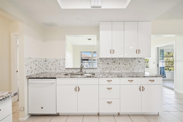 kitchen with decorative backsplash, light stone counters, white cabinets, dishwasher, and sink