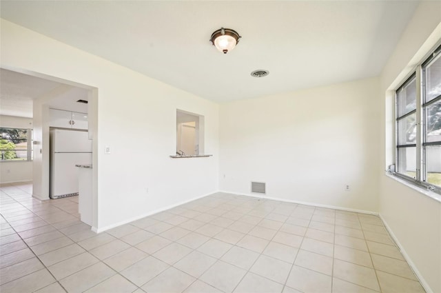 empty room with light tile patterned floors