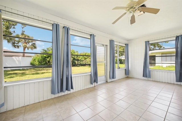 unfurnished sunroom with ceiling fan and plenty of natural light