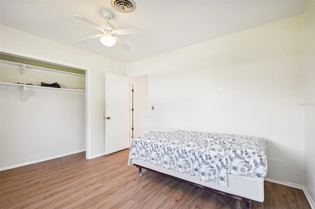 bedroom with a closet, ceiling fan, and wood-type flooring