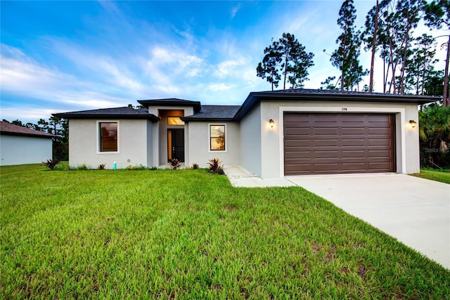 view of front of home with a front yard and a garage