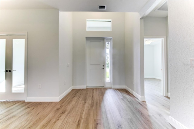 entrance foyer featuring french doors and light wood-type flooring