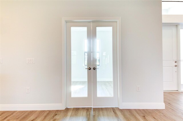 entryway with light wood-type flooring and french doors