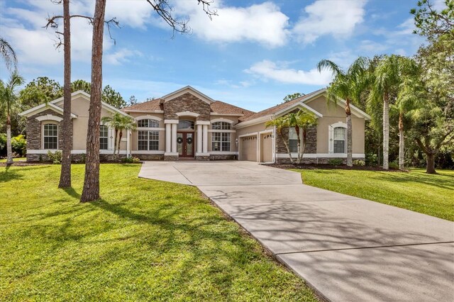 ranch-style home featuring a front yard and a garage