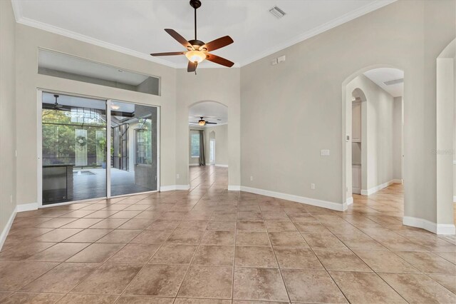 unfurnished room with ceiling fan, light tile patterned flooring, and crown molding