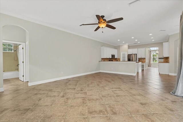 unfurnished living room featuring light tile patterned floors, ceiling fan, and crown molding