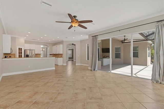 unfurnished living room with ceiling fan, light tile patterned floors, and crown molding