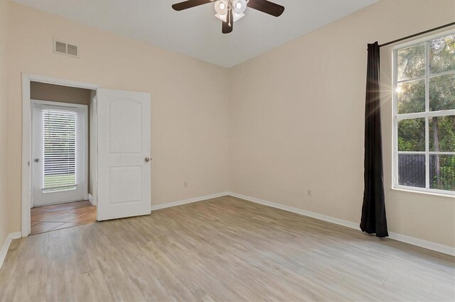 unfurnished room with light hardwood / wood-style floors, plenty of natural light, and ceiling fan