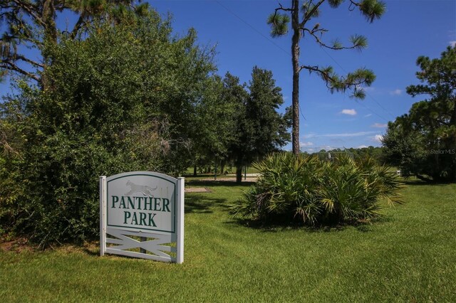 view of property's community with a lawn