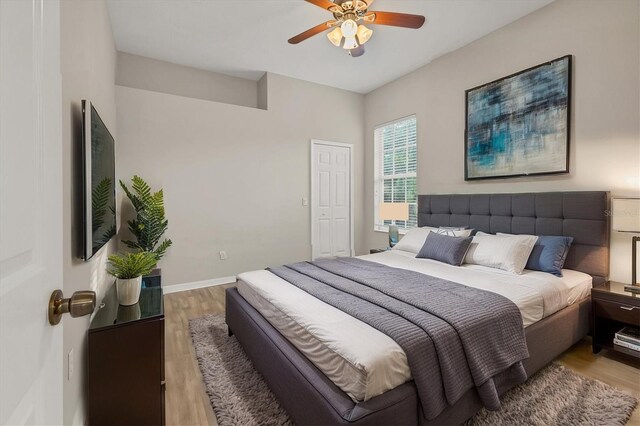 bedroom with ceiling fan and light hardwood / wood-style flooring