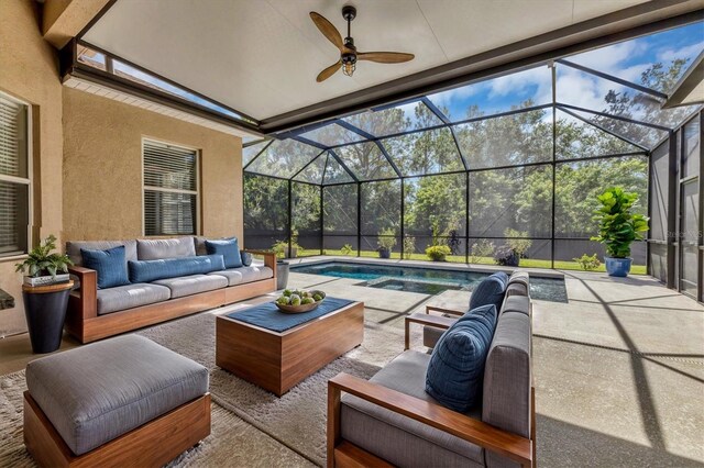 view of patio featuring ceiling fan, an outdoor living space, and glass enclosure