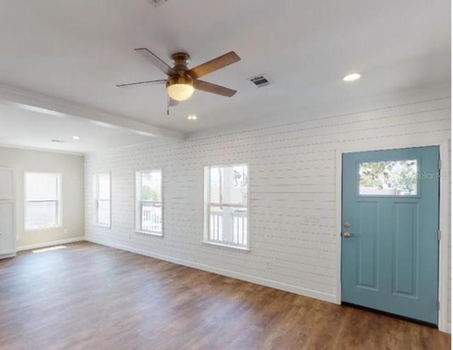 foyer featuring dark wood-style flooring, visible vents, a ceiling fan, beam ceiling, and brick wall