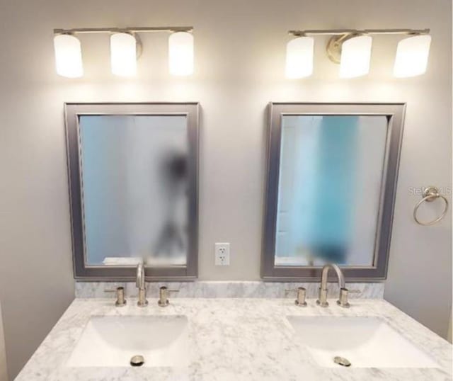 full bath featuring double vanity and a sink