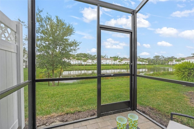 unfurnished sunroom featuring a water view and a healthy amount of sunlight