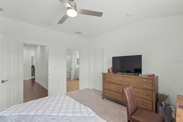 bedroom featuring ceiling fan, lofted ceiling, and light carpet