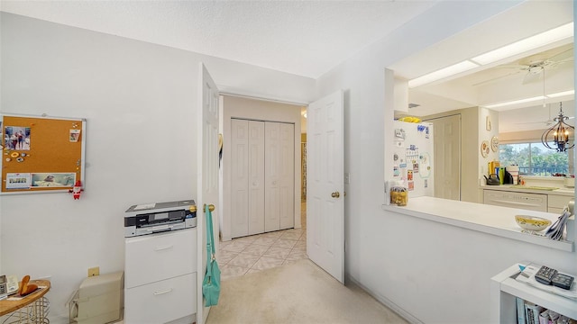 kitchen with ceiling fan, light colored carpet, and white appliances