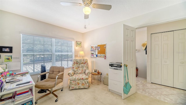 office area with a textured ceiling, light tile patterned flooring, and ceiling fan