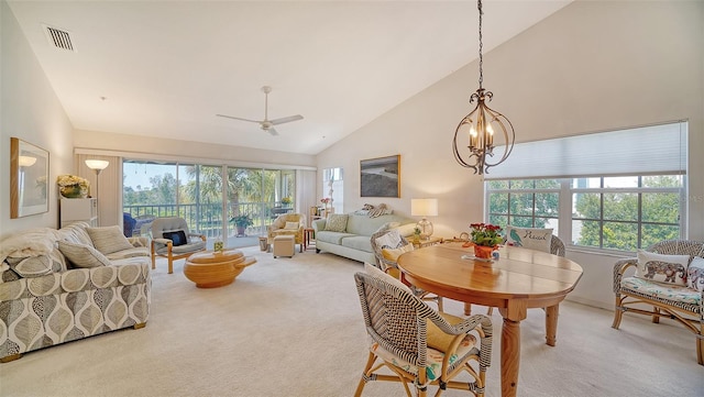 interior space with ceiling fan with notable chandelier, high vaulted ceiling, and carpet flooring